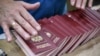 RUSSIA-PASSPORT -- An employee adjusts blank Russian passports at a Goznak factory in Moscow on July 11, 2019.